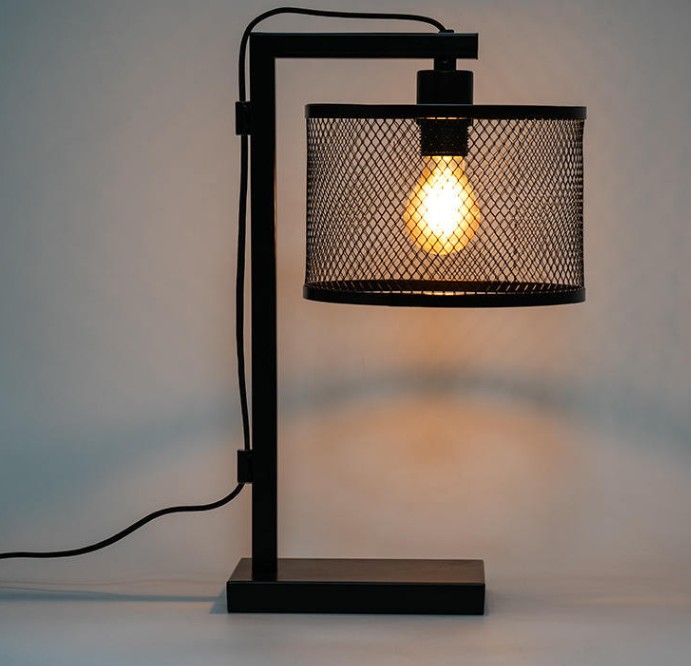 How does the Wrought Iron Decorative Table Lamp ensure the stability and durability of the product?