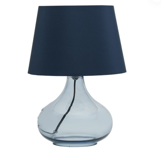 In addition to making the light warmer and softer, what other functions does the high transparency of the European Style Simple Glass Table Lamp have in creating the atmosphere of the room?